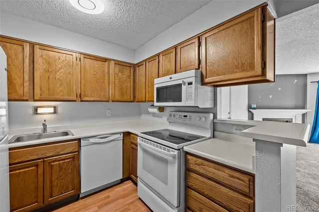 a kitchen with stainless steel appliances a stove sink microwave and cabinets