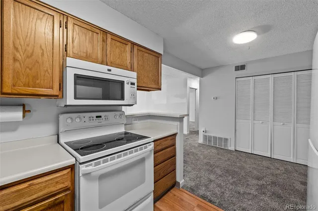 a kitchen with a stove and a microwave