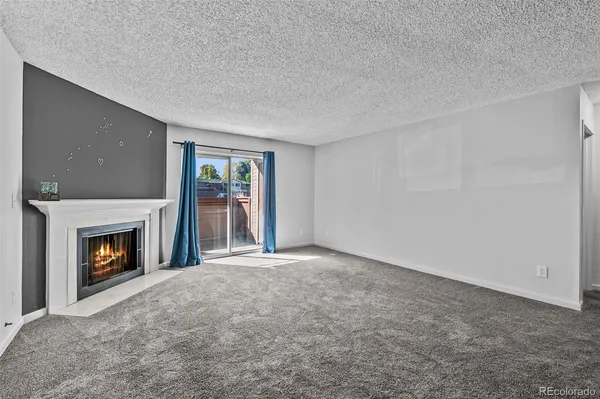 a view of empty room with a fireplace