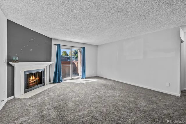 a view of empty room with a fireplace
