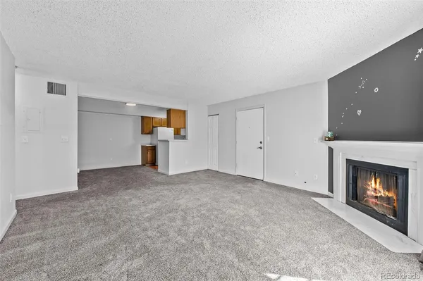 a view of empty room with a fireplace