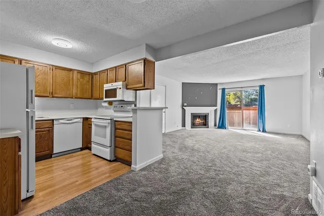 a kitchen with a refrigerator sink and cabinets
