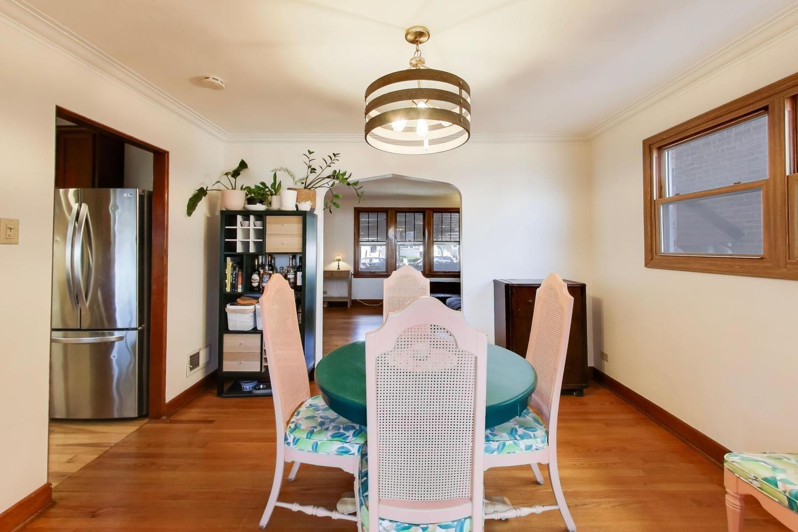 1811 Maple Avenue Berwyn, IL 60402 - Photo 9 of 31 a dining room with wooden floor a glass table and chairs