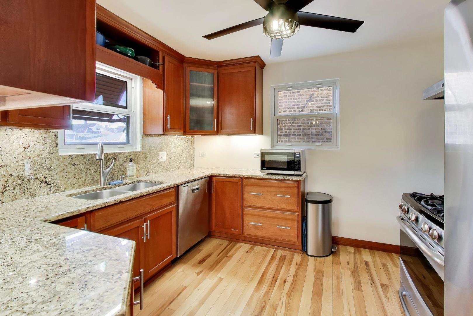 1811 Maple Avenue Berwyn, IL 60402 - Photo 10 of 31 a kitchen with stainless steel appliances granite countertop a sink stove and refrigerator