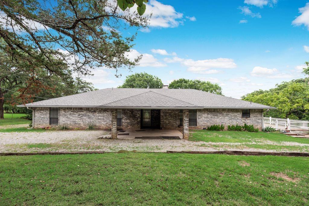 298 Butterfield Road Denison, TX 75021 - Photo 31 of 34 Single-story residence featuring a gray brick exterior and a covered patio entrance