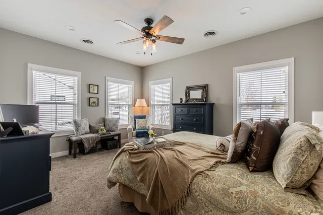 a bedroom with a bed and a chandelier