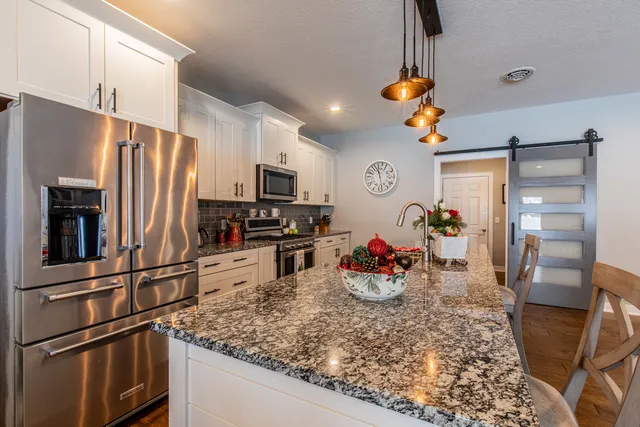 a kitchen with refrigerator and storage