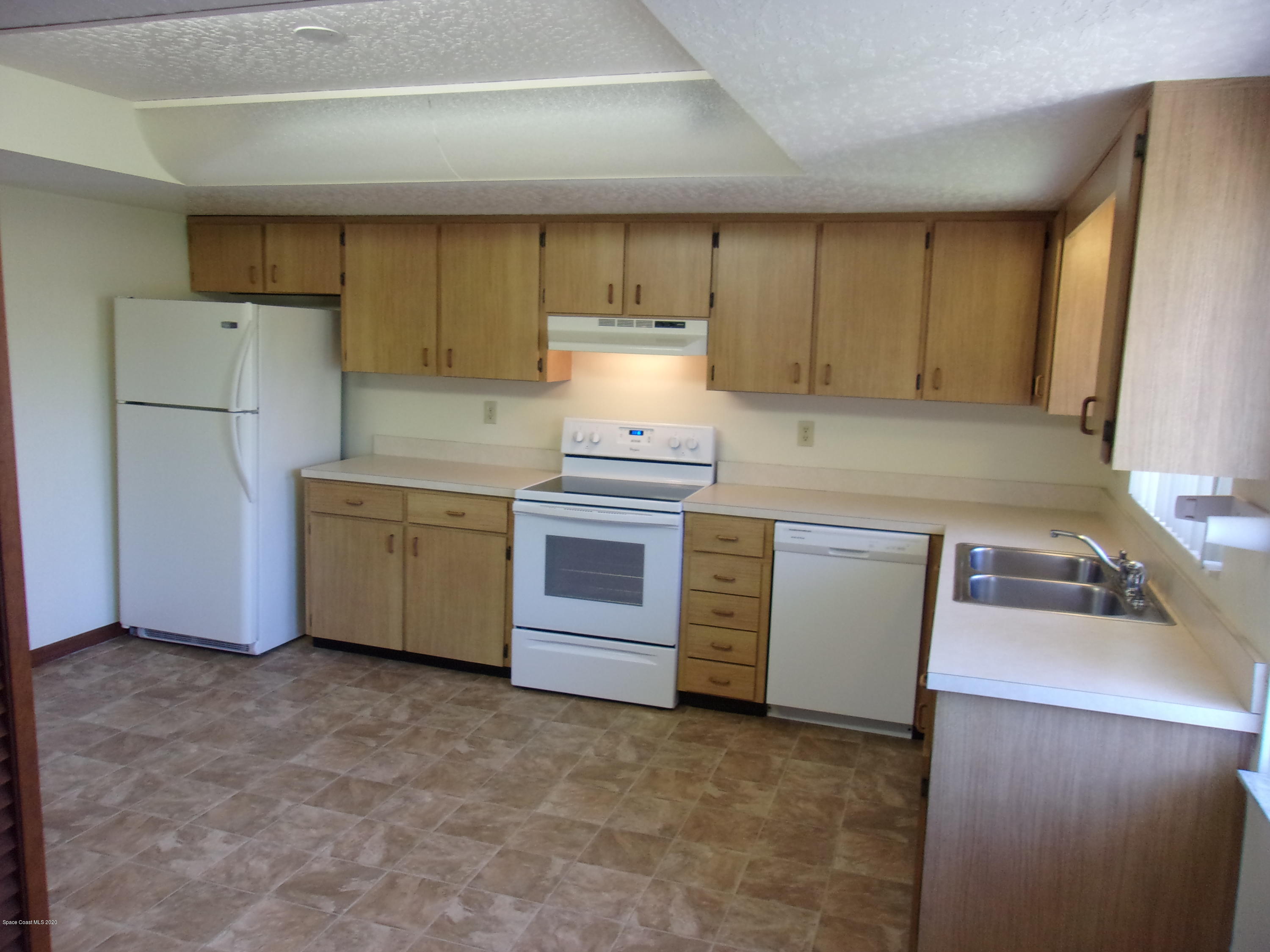 418 South Atlantic Avenue, Unit 3 Cocoa Beach, FL 32931 - Photo 14 of 29 a kitchen with a stove and a cabinets