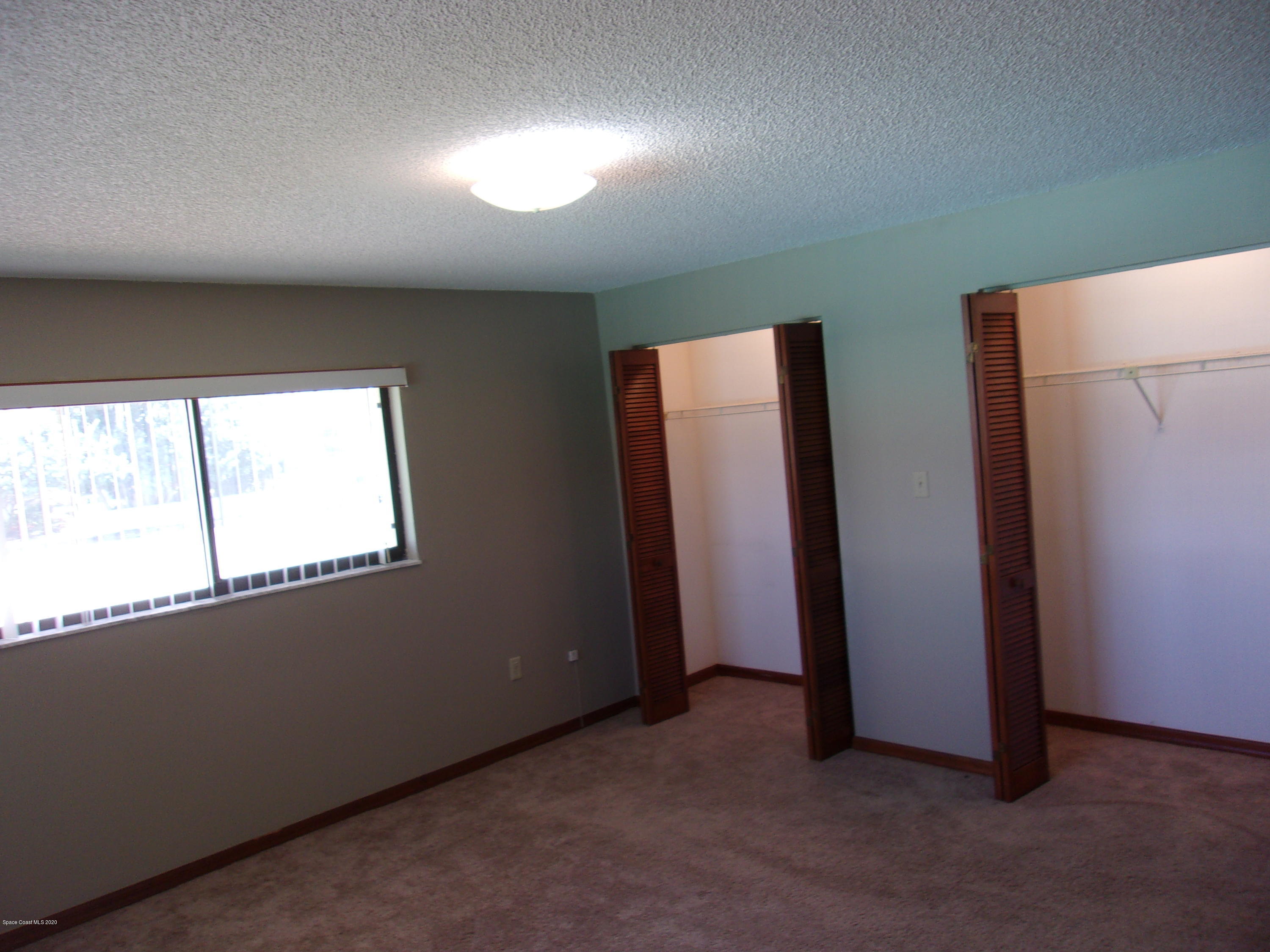 418 South Atlantic Avenue, Unit 3 Cocoa Beach, FL 32931 - Photo 28 of 29 an empty room with windows