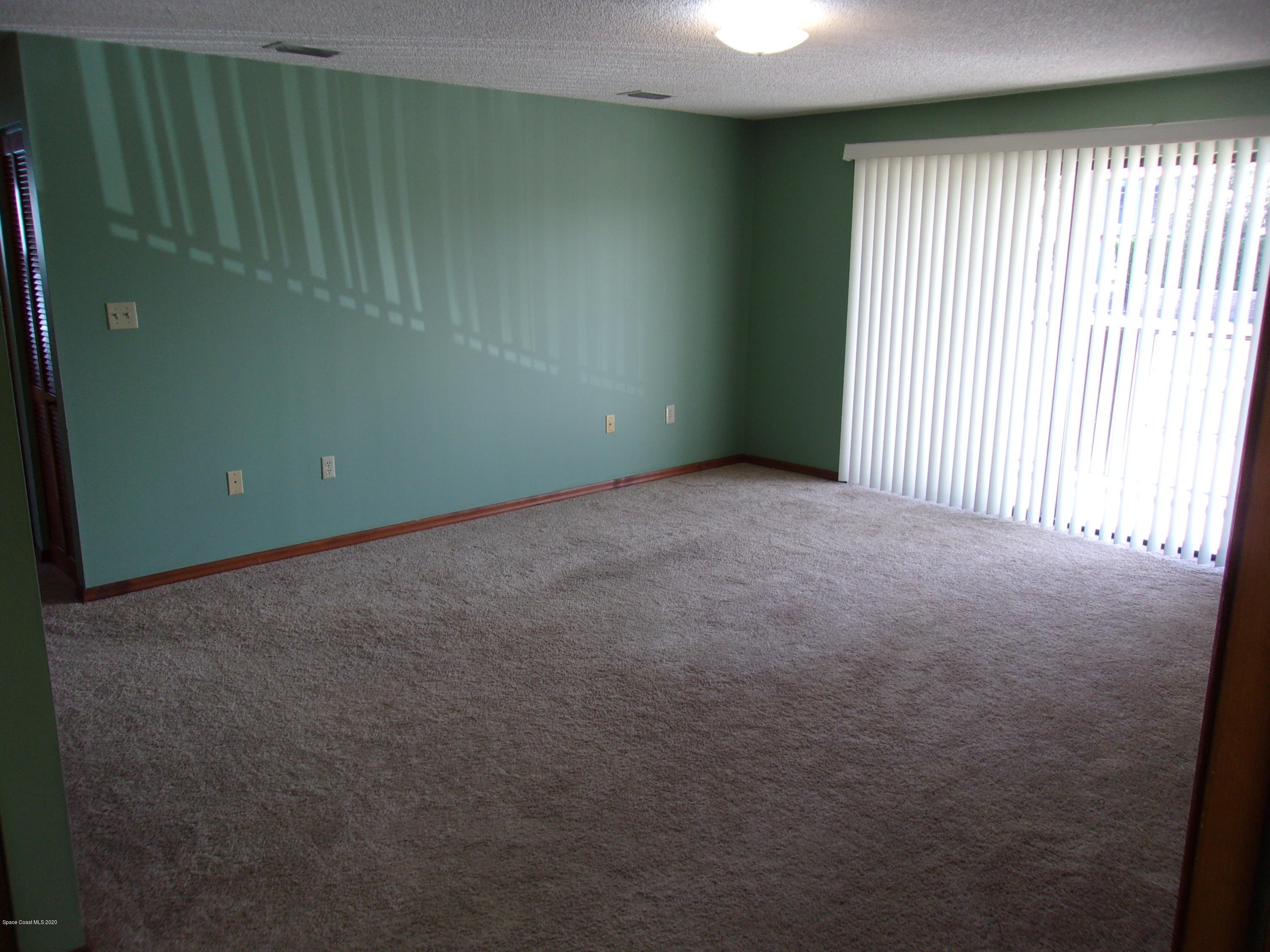 418 South Atlantic Avenue, Unit 3 Cocoa Beach, FL 32931 - Photo 3 of 29 an empty room with windows