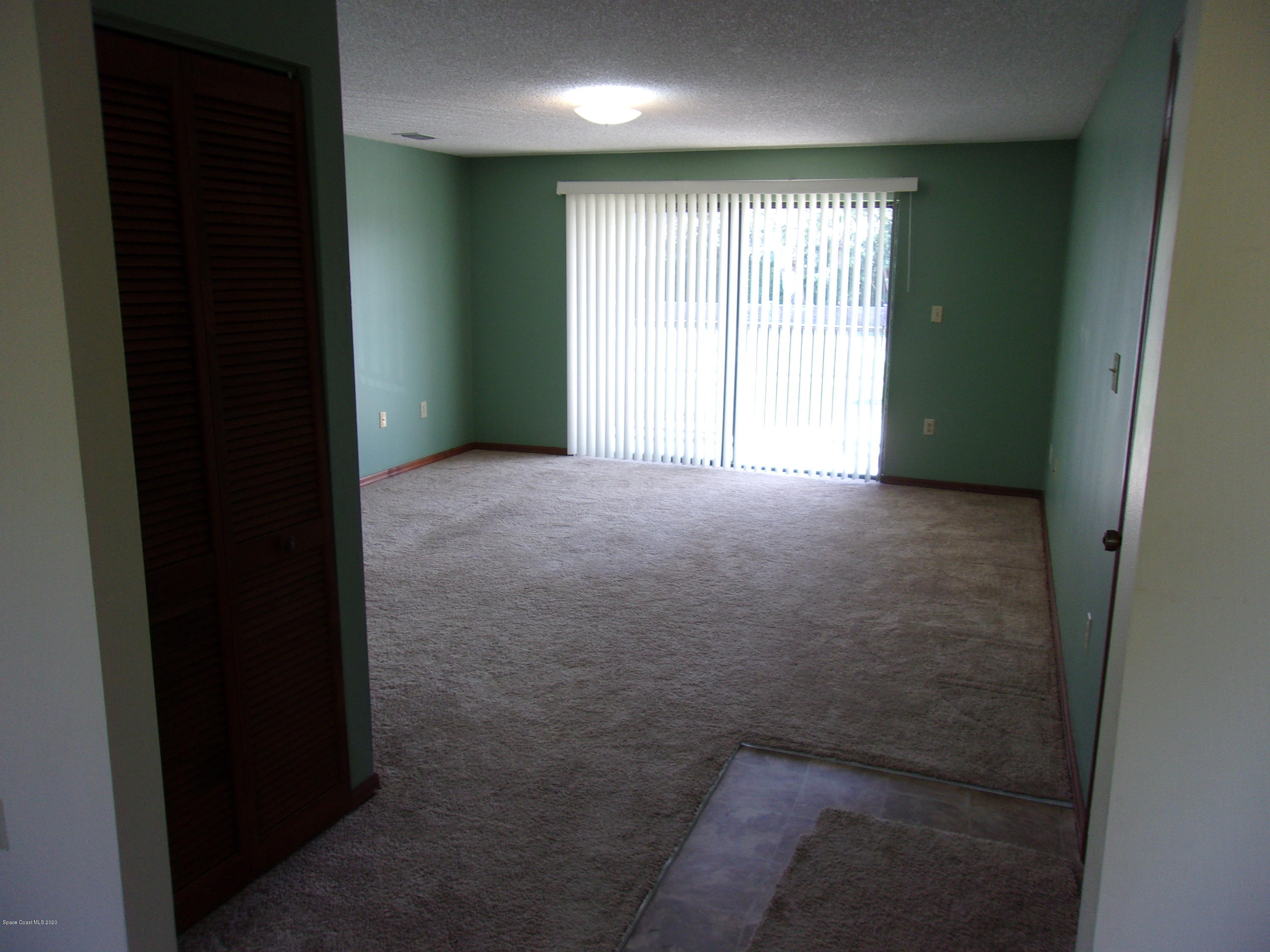 418 South Atlantic Avenue, Unit 3 Cocoa Beach, FL 32931 - Photo 4 of 29 a view of an empty room with a window
