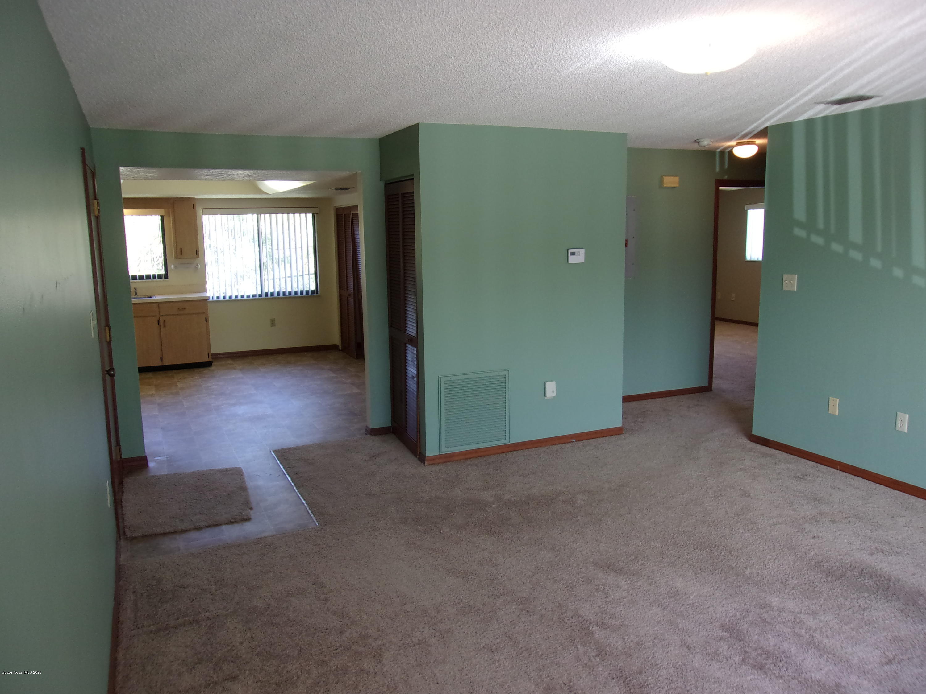 418 South Atlantic Avenue, Unit 3 Cocoa Beach, FL 32931 - Photo 5 of 29 a view of a room with window and stairs