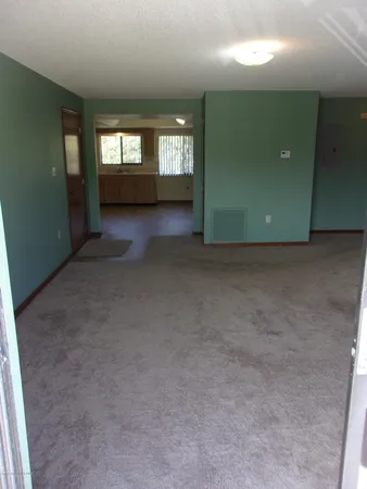 an empty room with windows and closet
