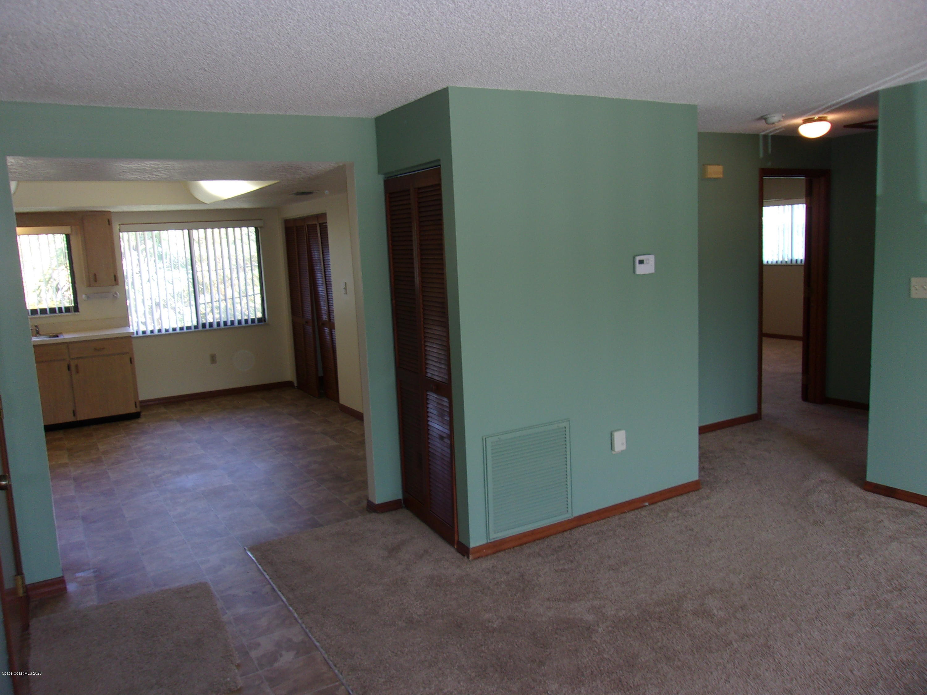 418 South Atlantic Avenue, Unit 3 Cocoa Beach, FL 32931 - Photo 10 of 29 an empty room with windows and closet