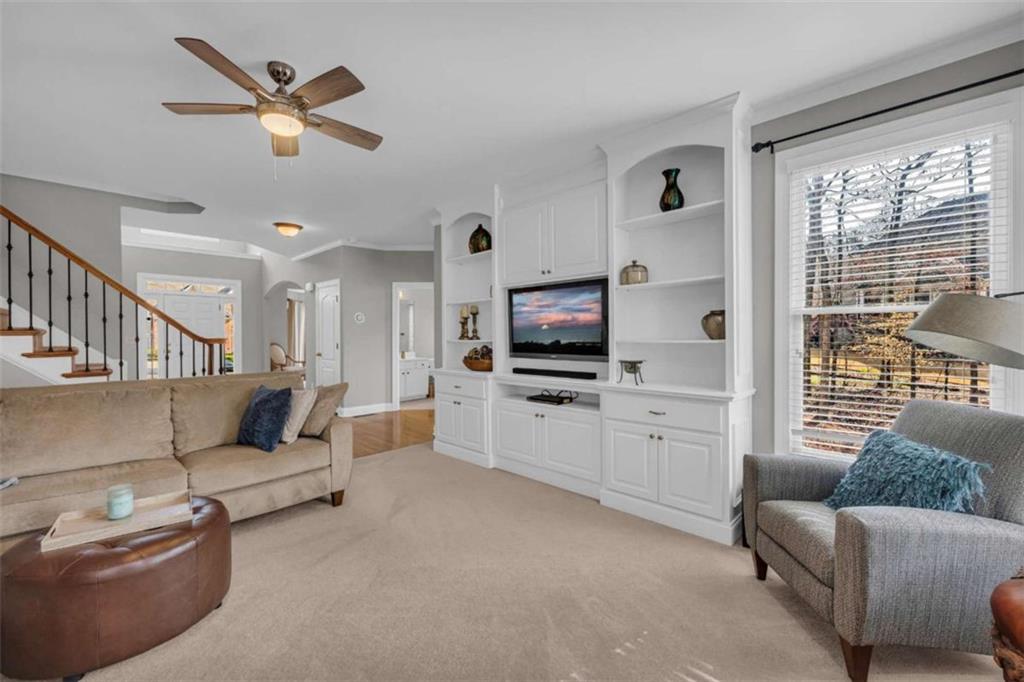3540 Sentry View Trace Suwanee, GA 30024 - Photo 11 of 70 a living room with furniture ceiling fan and a window