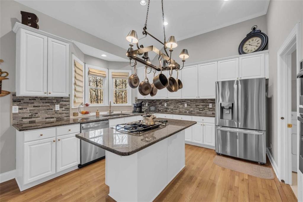 3540 Sentry View Trace Suwanee, GA 30024 - Photo 20 of 70 a kitchen with stainless steel appliances granite countertop a sink stove and refrigerator