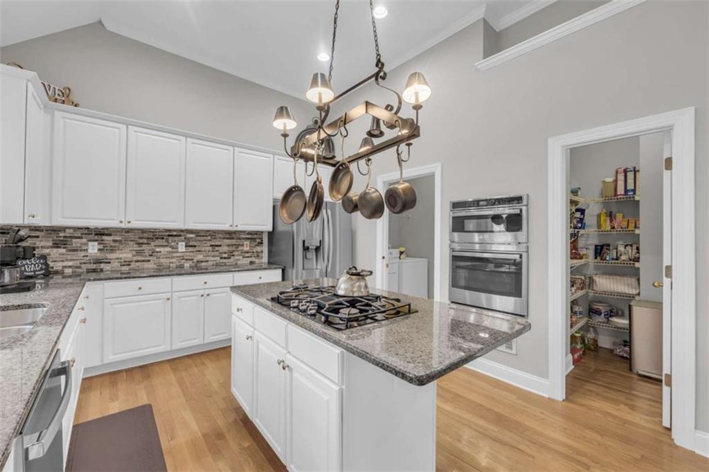 3540 Sentry View Trace Suwanee, GA 30024 - Photo 21 of 70 a kitchen with stainless steel appliances granite countertop a sink stove and refrigerator