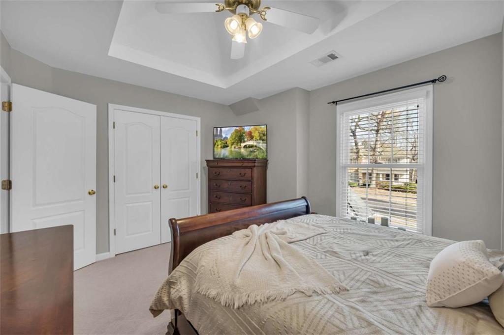 3540 Sentry View Trace Suwanee, GA 30024 - Photo 24 of 70 a bedroom with a bed and a chandelier