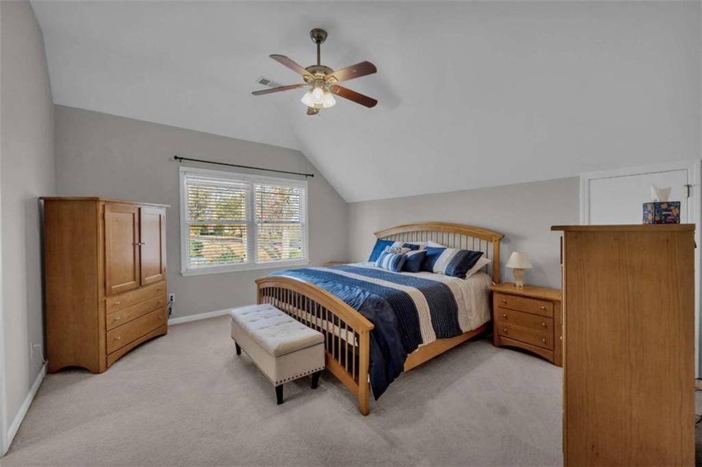 3540 Sentry View Trace Suwanee, GA 30024 - Photo 29 of 70 a spacious bedroom with a bed and window