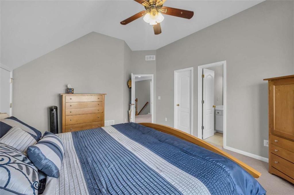 3540 Sentry View Trace Suwanee, GA 30024 - Photo 30 of 70 a bedroom with a bed and a chandelier