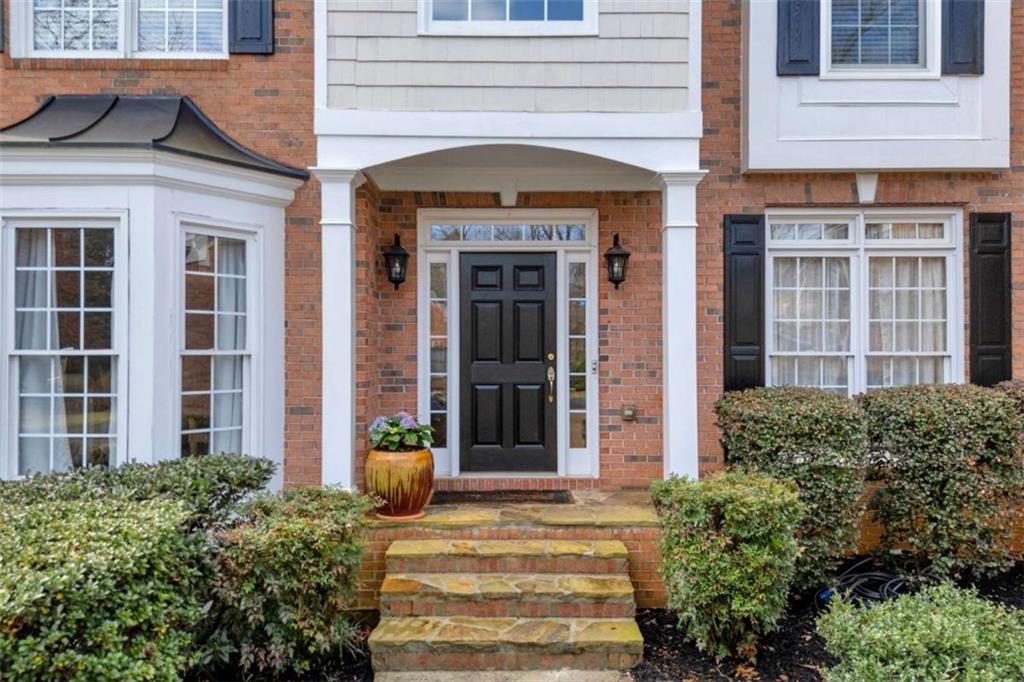 3540 Sentry View Trace Suwanee, GA 30024 - Photo 3 of 70 front view of a brick house with a large window