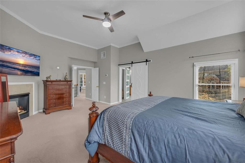 3540 Sentry View Trace Suwanee, GA 30024 - Photo 34 of 70 a spacious bedroom with a bed and a television