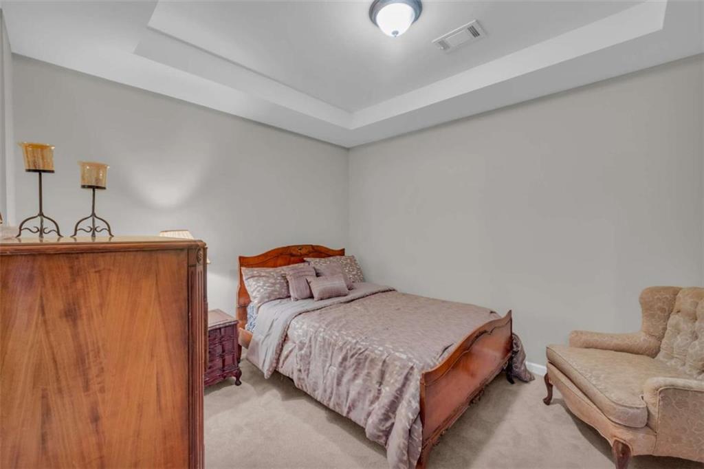 3540 Sentry View Trace Suwanee, GA 30024 - Photo 60 of 70 a bedroom with a bed and a couch