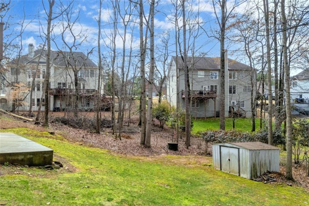 3540 Sentry View Trace Suwanee, GA 30024 - Photo 69 of 70 a view of a backyard with plants and brick wall
