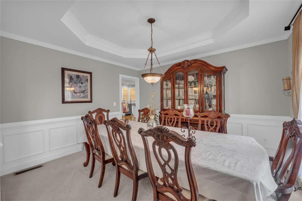 3540 Sentry View Trace Suwanee, GA 30024 - Photo 8 of 70 a view of a a dining room with furniture window and wooden floor