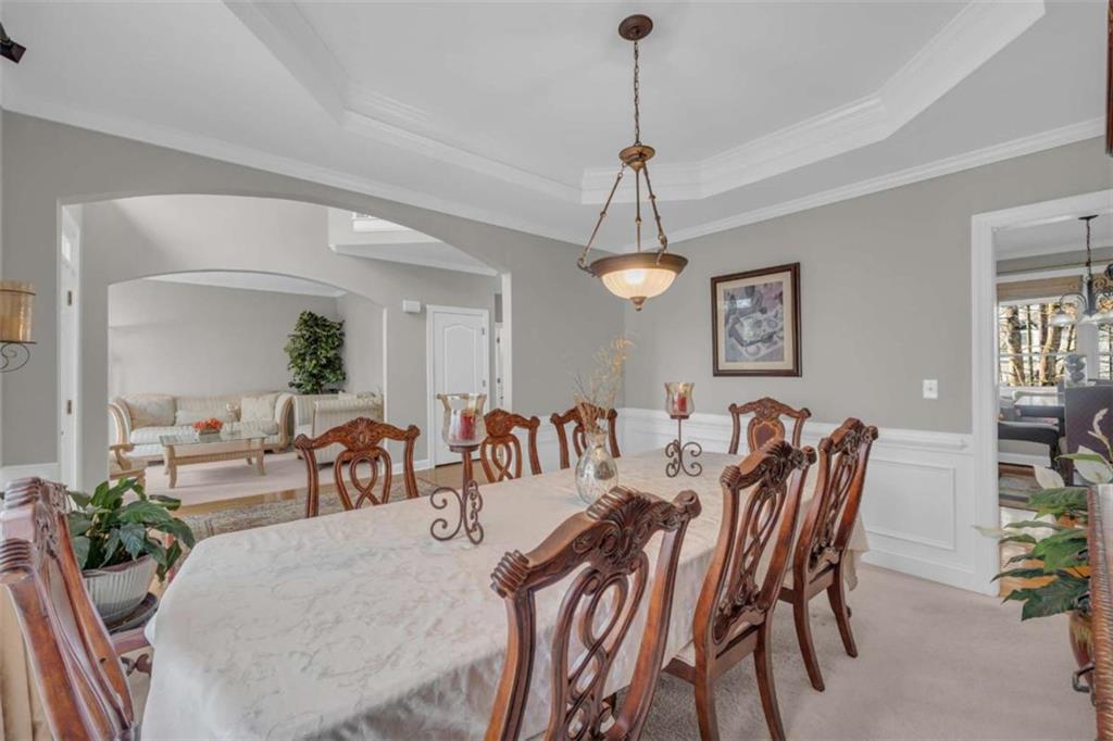3540 Sentry View Trace Suwanee, GA 30024 - Photo 9 of 70 a view of a dining room and livingroom with furniture wooden floor a chandelier