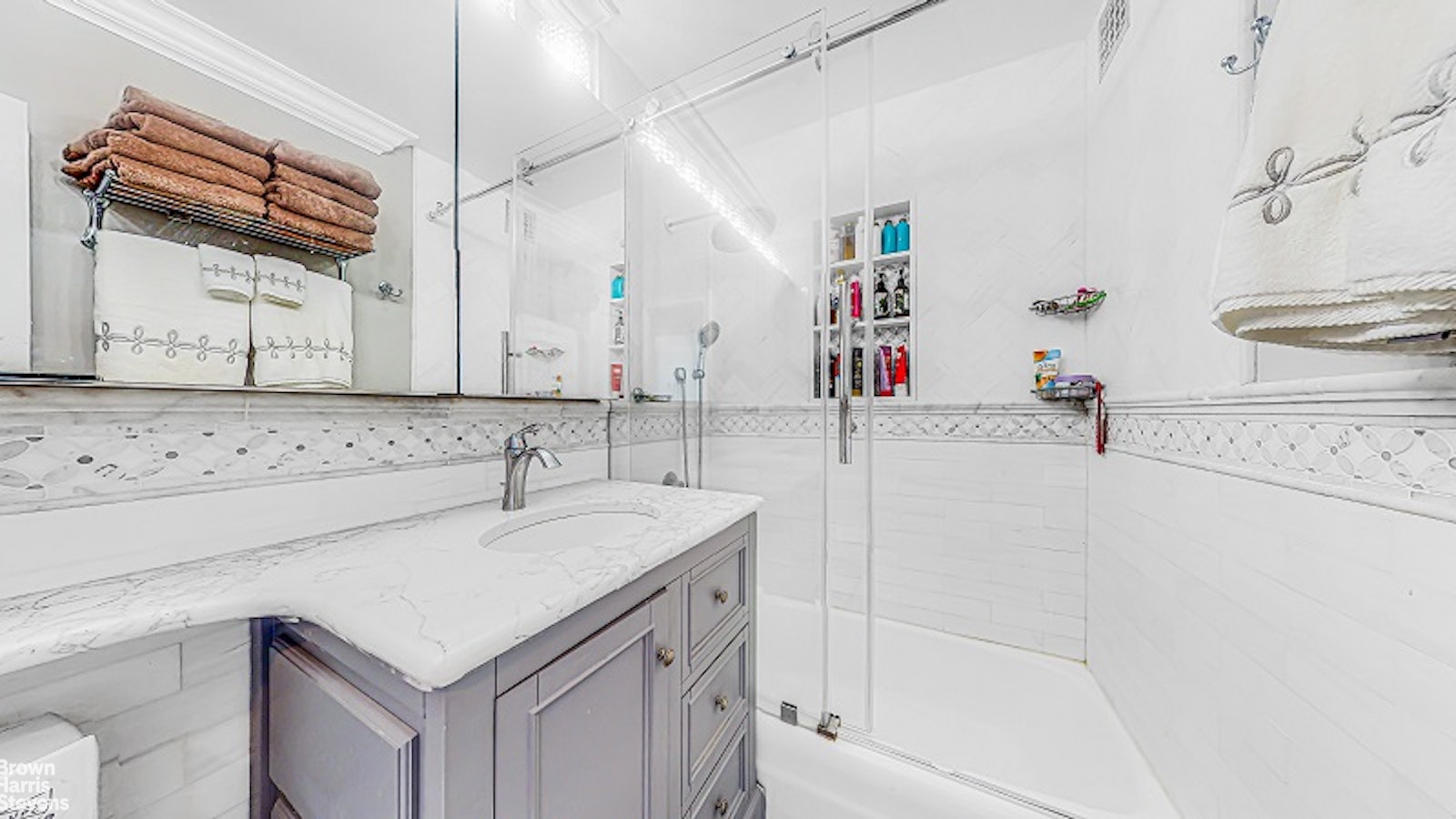 345 East 80th Street, Unit 19EF Manhattan, NY 10075 - Photo 21 of 32 a bathroom with a sink a vanity and a mirror