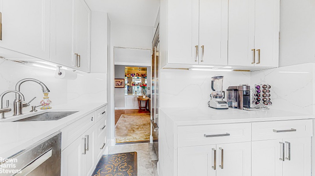 345 East 80th Street, Unit 19EF Manhattan, NY 10075 - Photo 4 of 32 a kitchen with stainless steel appliances granite countertop a sink and cabinets