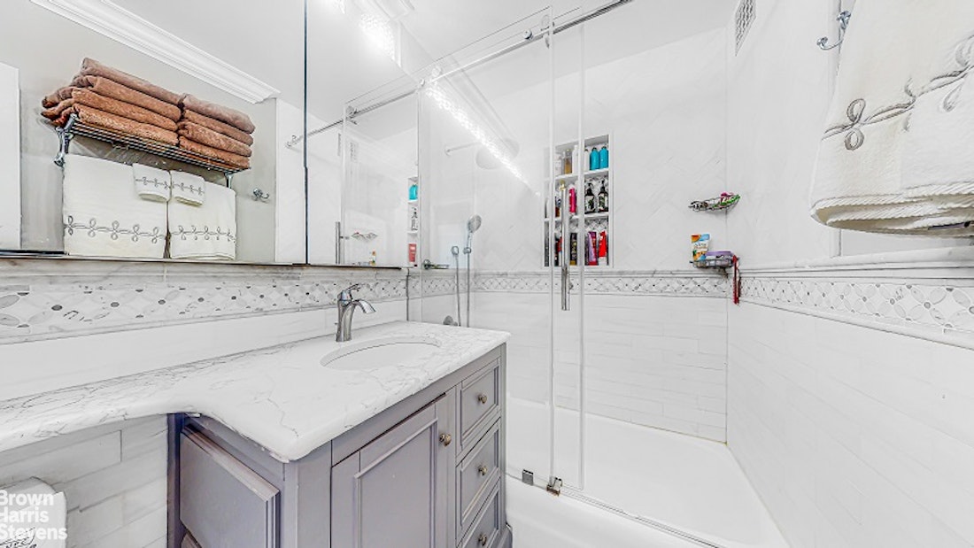 345 East 80th Street, Unit 19EF Manhattan, NY 10075 - Photo 9 of 32 a bathroom with a sink a vanity and a mirror