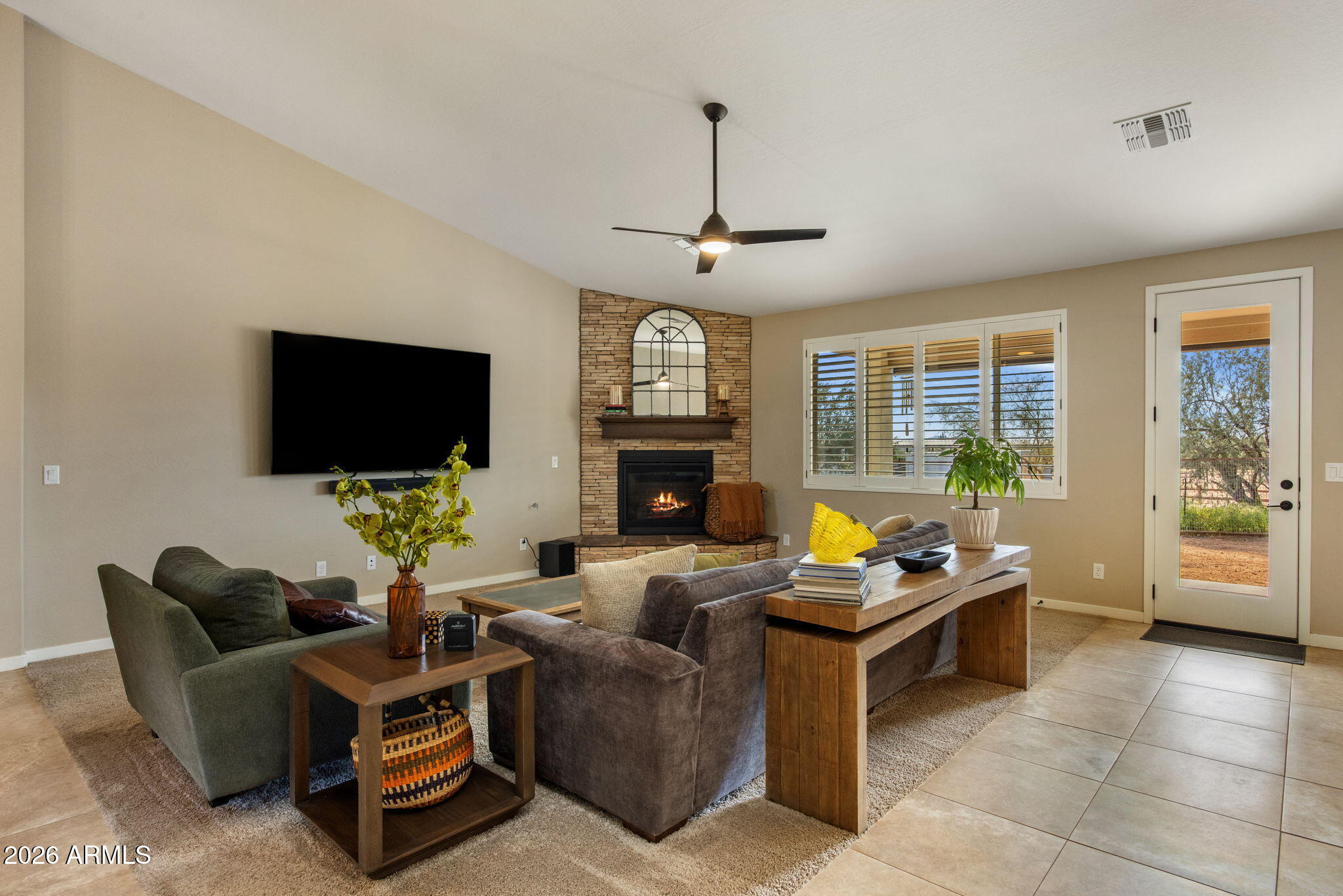 27412 North 170th Street Rio Verde, AZ 85263 - Photo 2 of 28 a living room with fireplace furniture and a flat screen tv