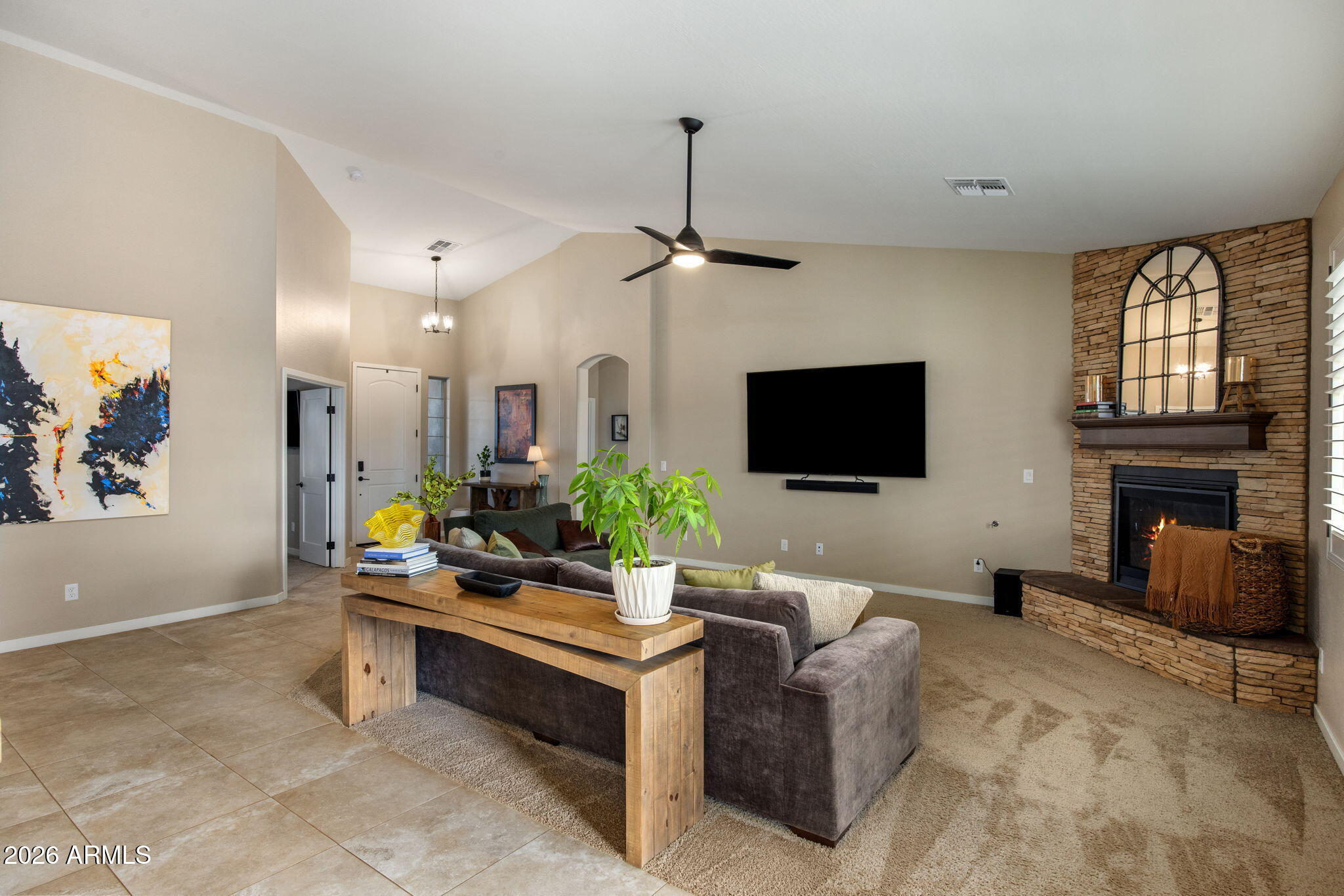 27412 North 170th Street Rio Verde, AZ 85263 - Photo 6 of 28 a living room with furniture a flat screen tv and a fireplace