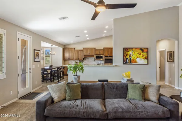 a living room with furniture and a wall painting