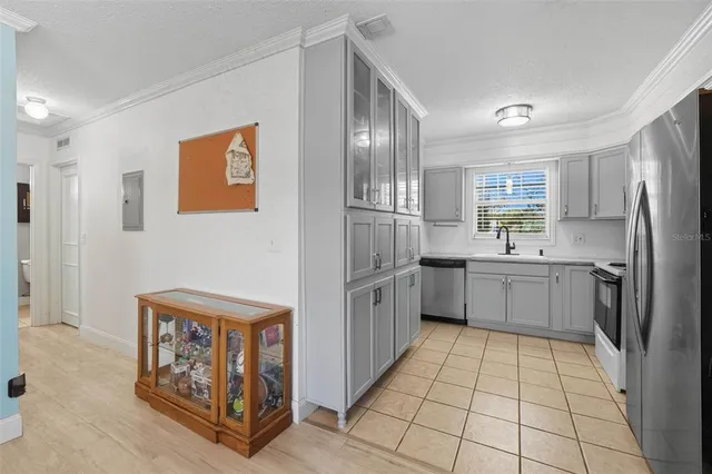 a kitchen with stainless steel appliances a refrigerator sink and cabinets