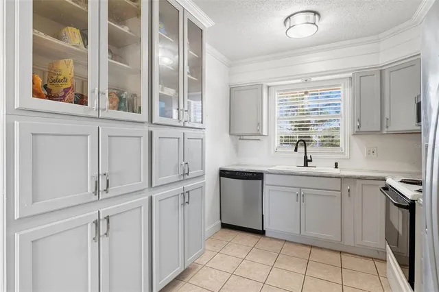 a kitchen with cabinets and window