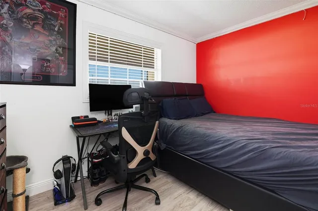 a bedroom with a bed and a desk