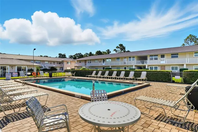 a view of a swimming pool with an outdoor seating