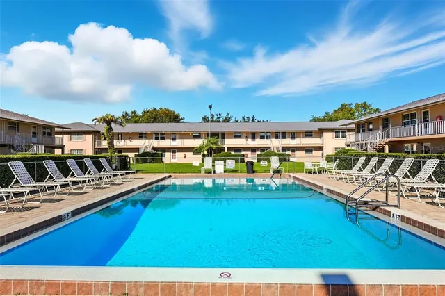 a view of a swimming pool with a table and chairs