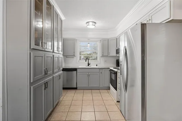 a kitchen with a refrigerator sink and cabinets