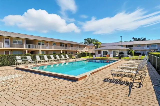 a view of swimming pool with seating space and deck