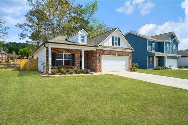 a view of a house with a yard and plants