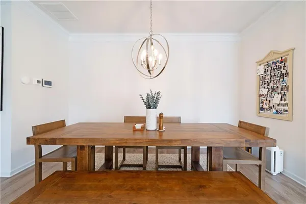 a living room with furniture kitchen view and a chandelier