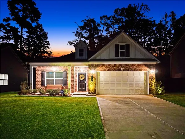 a front view of a house with garden