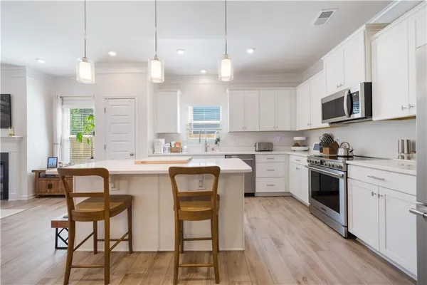 a kitchen with a sink stove and cabinets