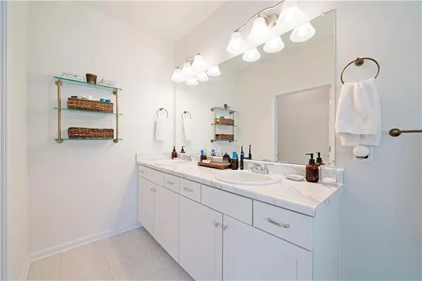 a bathroom with a sink vanity and a mirror