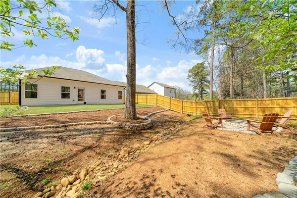 a view of yard with swimming pool and green space
