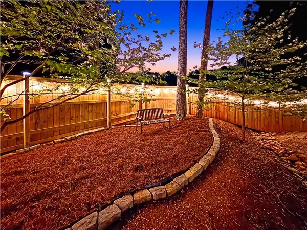 a view of a backyard with wooden fence